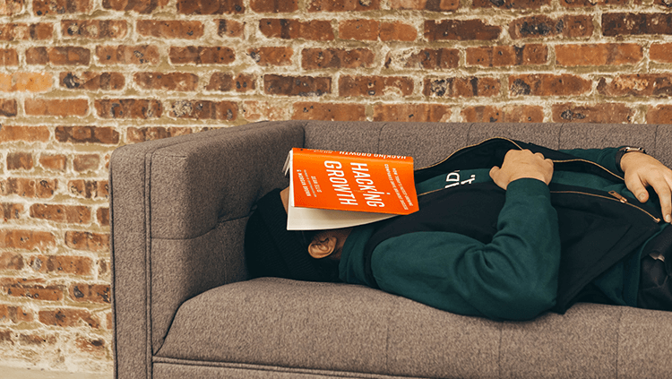 man asleep with a book on his face