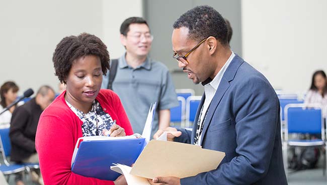 Two neuroscientists discuss a manuscript. 