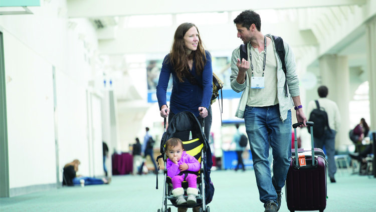 Two Neuroscience 2018 attendees pushing a child in a stroller