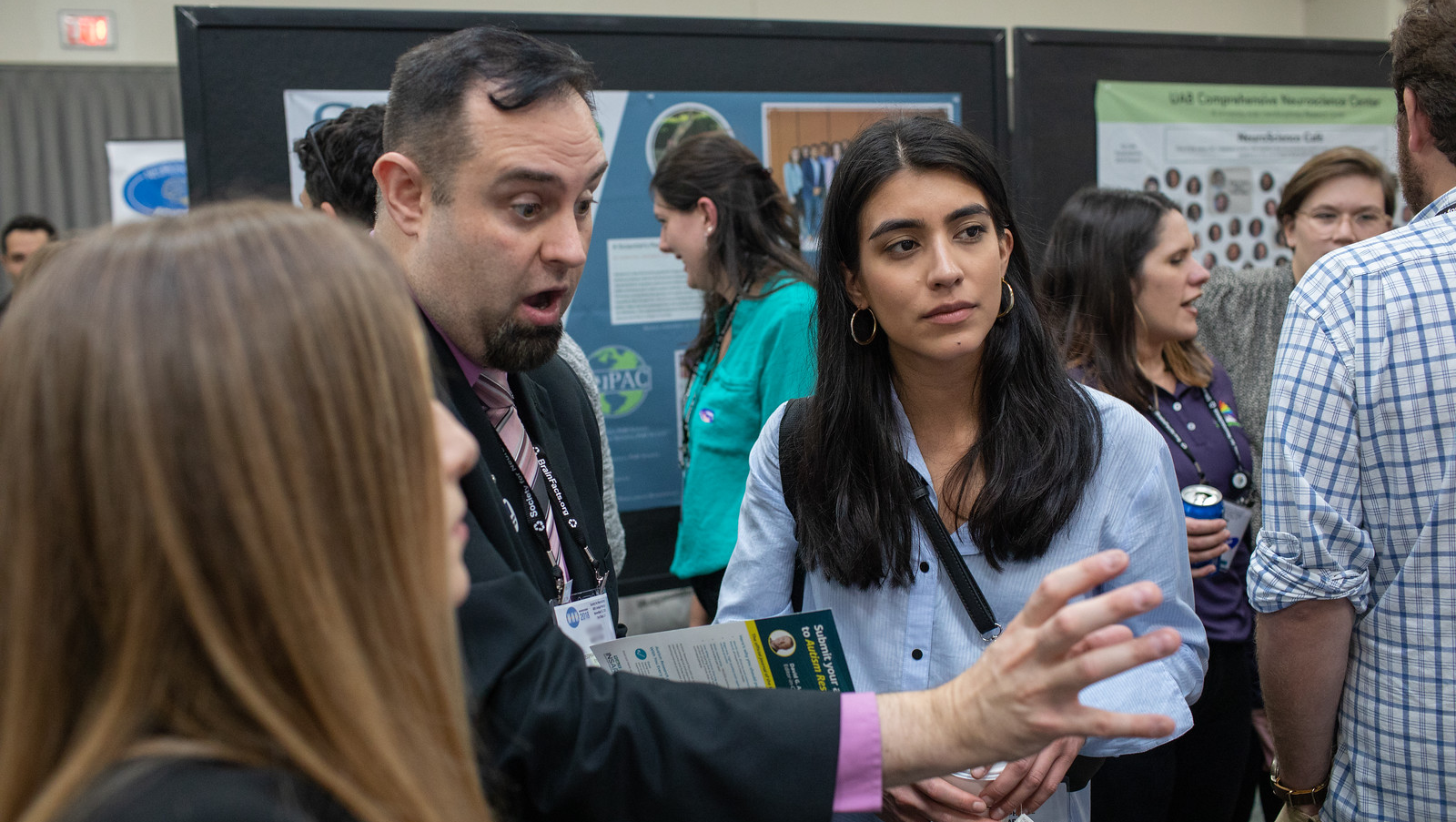 SfN advocate Michael Nestor (center) shares a poster presentation highlighting advocacy activities his local chapter has participated in.