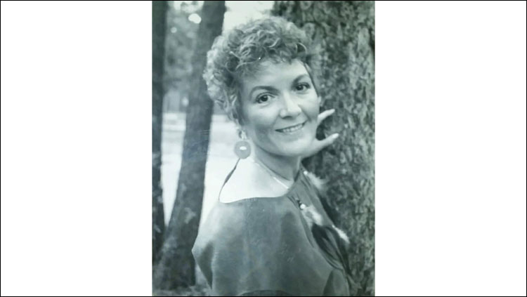 Image of Martine Robards standing by a tree.