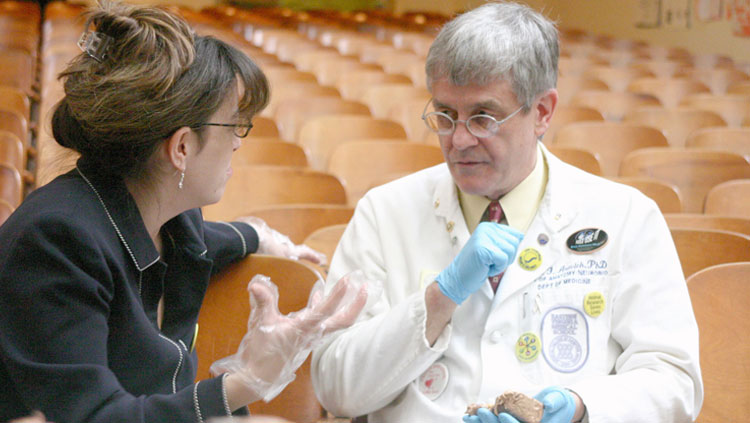 Dr. Paul Aravich from Eastern Virginia Medical School holding a brain model