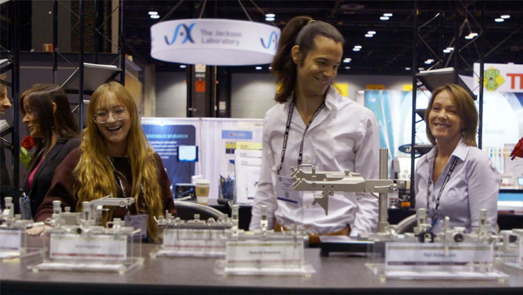 Three attendees at the Neuroscience 2019 exhibit floor