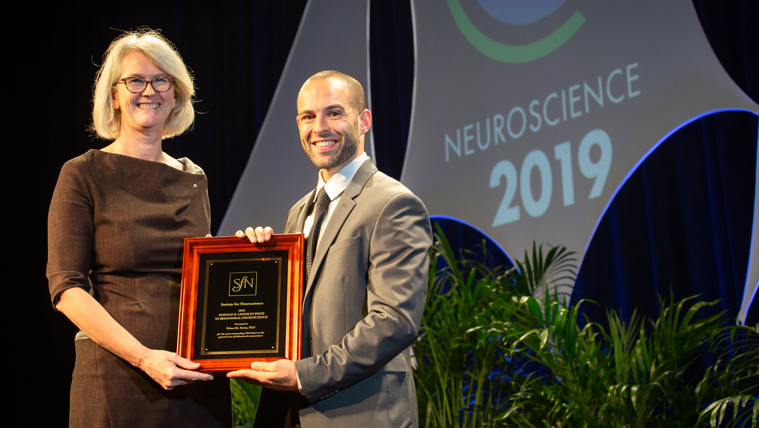 Brian M. Sweis, PhD (right), of the University of Minnesota, accepts the Donald B. Lindsley Prize in Behavioral Neuroscience.