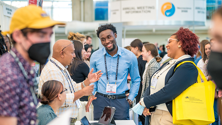 Attendees engage with exhibitors at the Grad School Fair at Neuroscience 2022 in San Diego