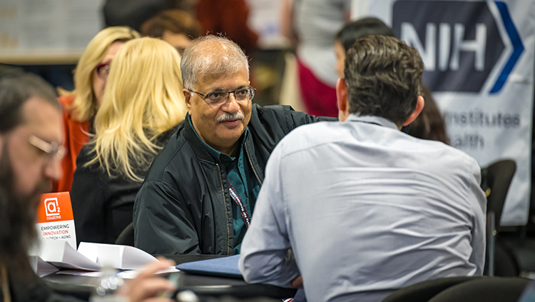 Neuroscientists having conversation and networking at Neuroscience 2024